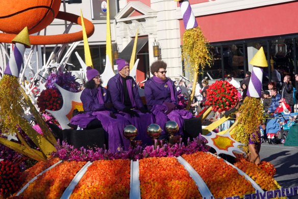 Lakers legion Kareem Abdul-Jabbar rides on the Los Angeles Lakers float.